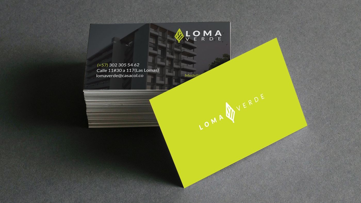 Stack of business cards with Loma Verde logo on green and a building image with contact details.